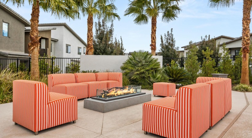 a couple of red couches in a backyard