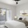 a bedroom with a fan and a bed