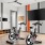 a room with exercise equipment and a tv