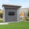 a grey house with a green lawn