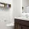 a bathroom with a sink toilet and mirror
